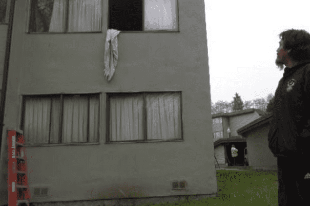 man standing in front of apartment building