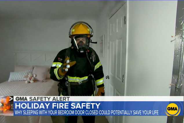 man in fire gear in closed door bedroom