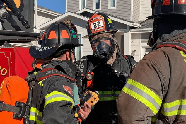 firefighters in turnout gear talking